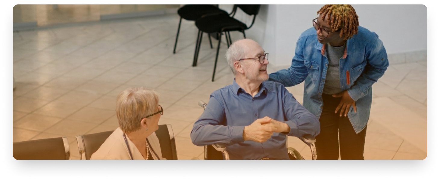 Caregiver helping patient in wheelchair